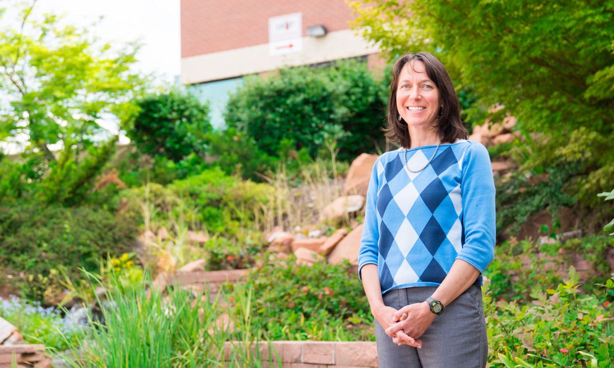 Shelly Bosworth stands outside in a garden by ARUP.