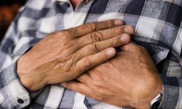 Hands over heart image of man American Heart Month
