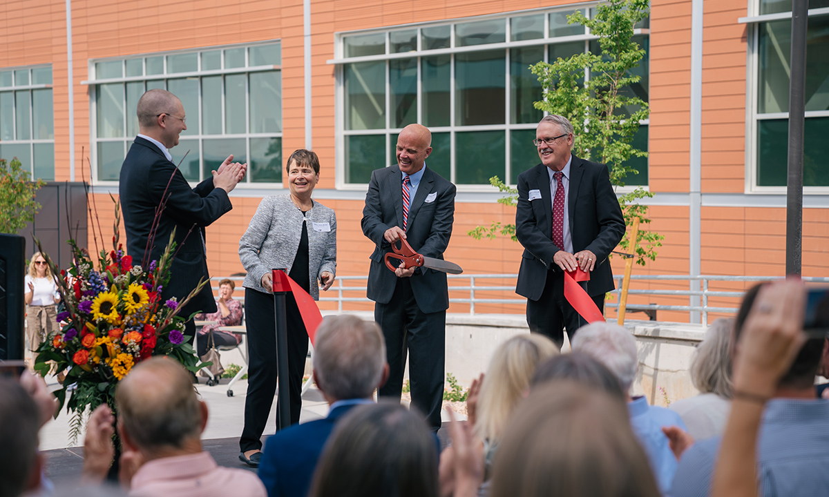 Jonathan Genzen, Sherrie L. Perkins, Andy Theurer, and Peter Jensen cut a red ribbon to officially open ARUP's new laboratory facility.