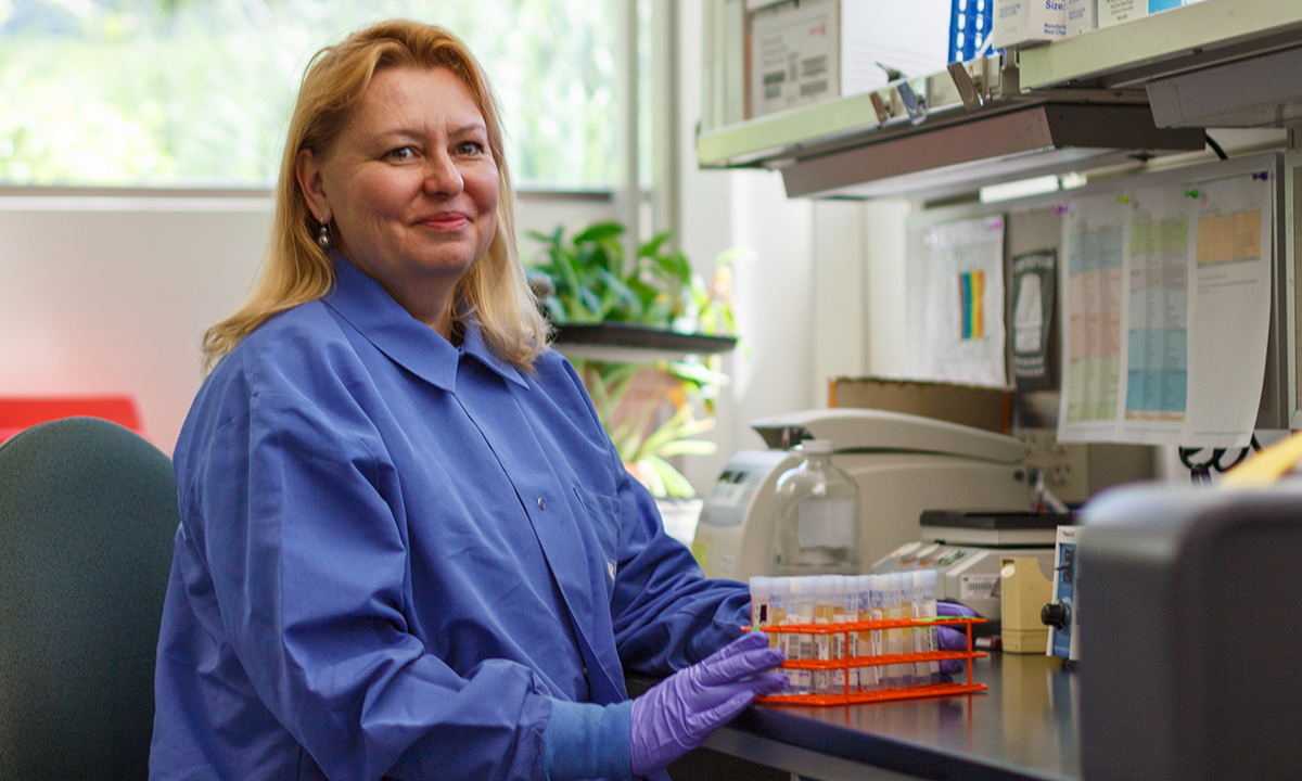 Patricia Slev, PhD, ARUP Immunology Division section chief and University of Utah associate professor of pathology sits at a desk