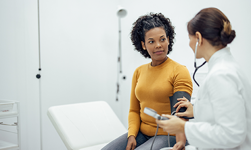 A female clinician talks with a female patient