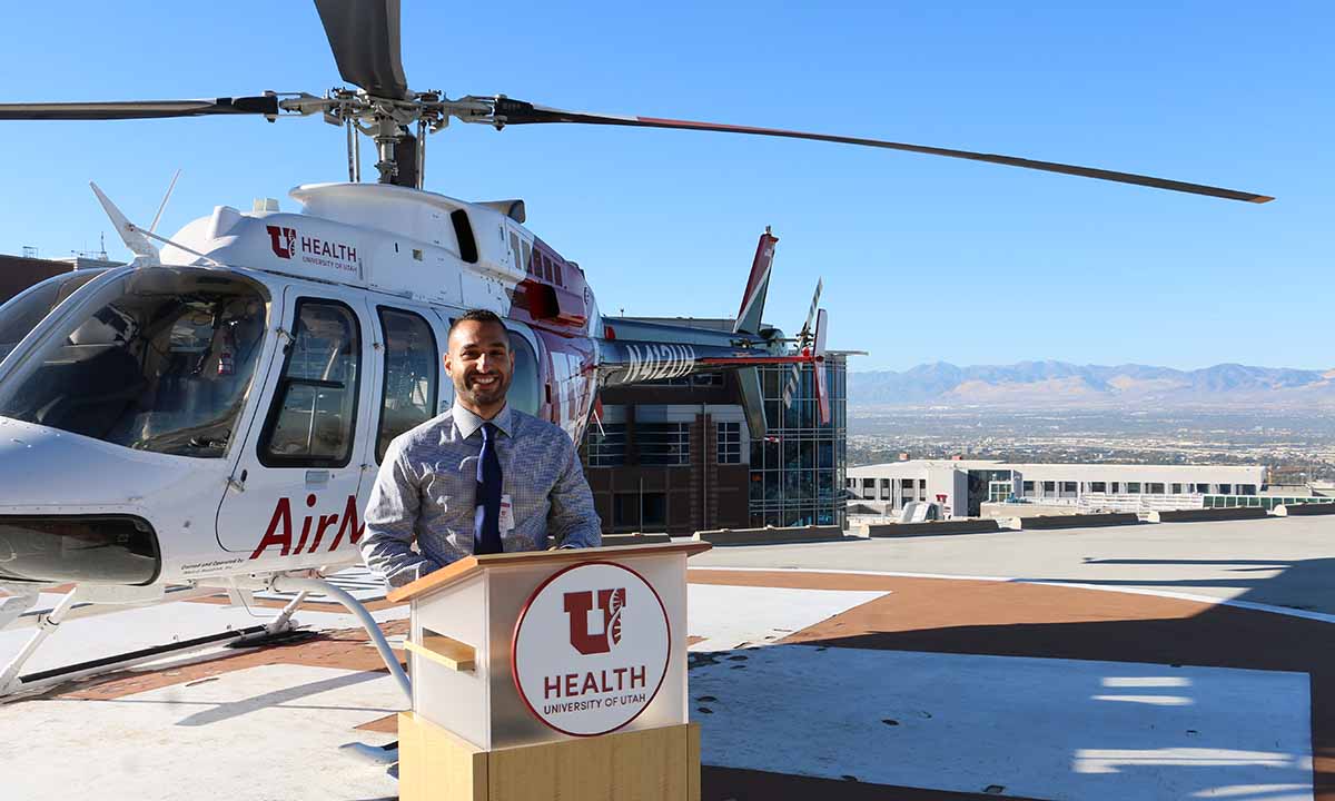 Waseem Anani stands in front of an AirMed helicopter.
