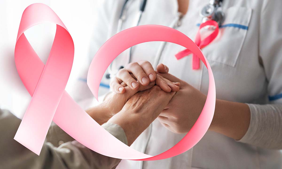Clinician is holding patient's hands. A pink ribbon is overlayed on the hands.