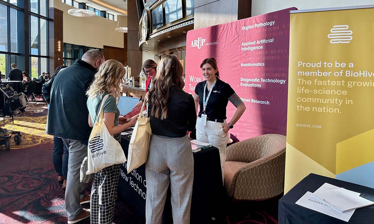 Erica Clyde stands with a group of attendees at BioHive Live.