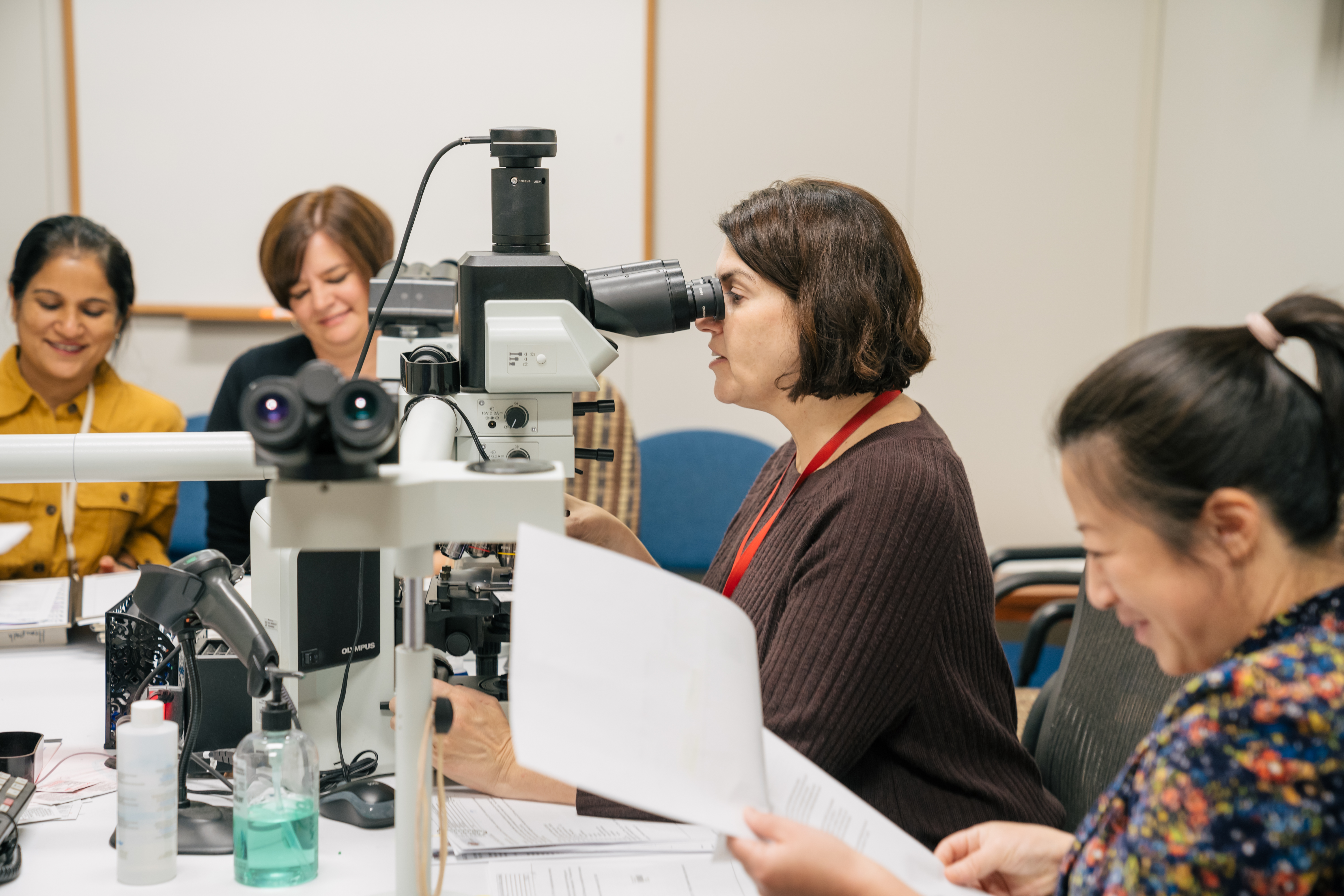 Archana Agarwal, Kristi Smock, Tracy George, and Peng Li work in a lab.