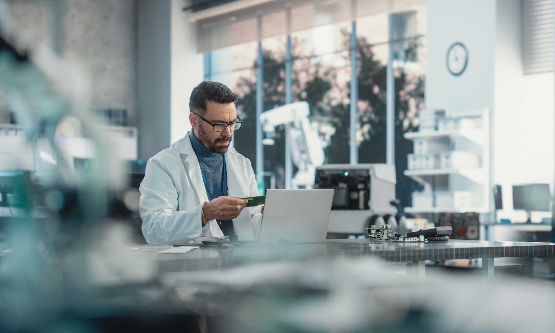 A man sits at a computer in a lab