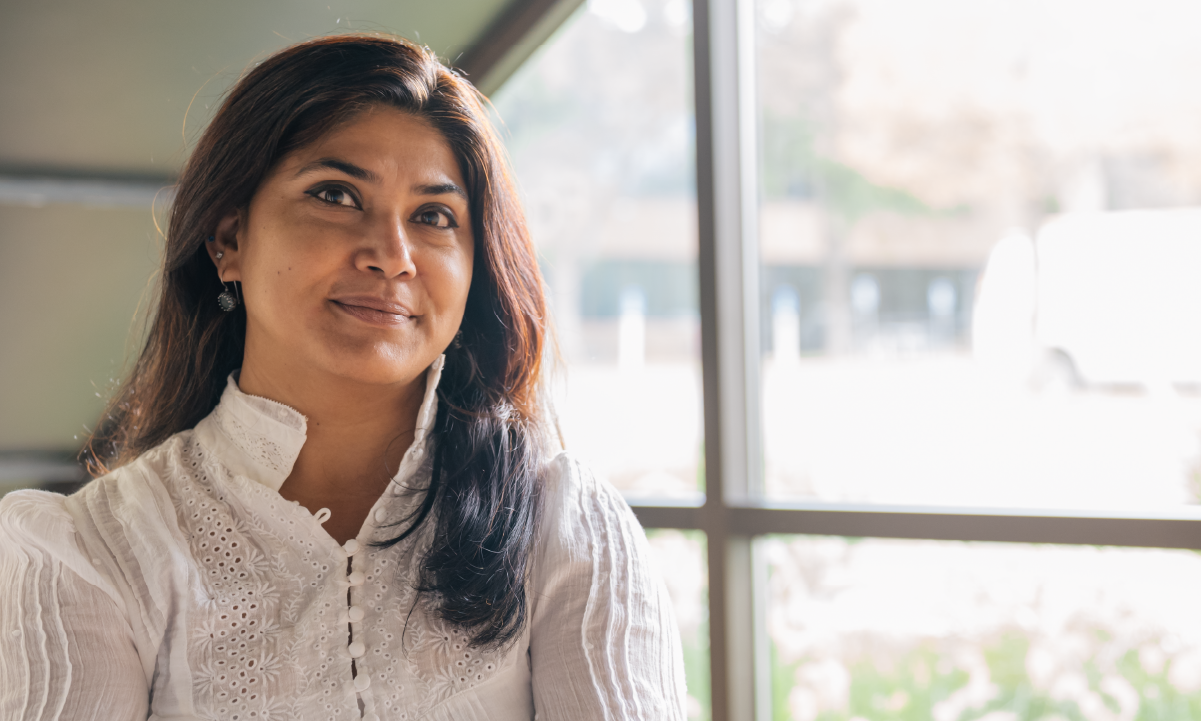 Dipanwita Banerjee stands by a window.