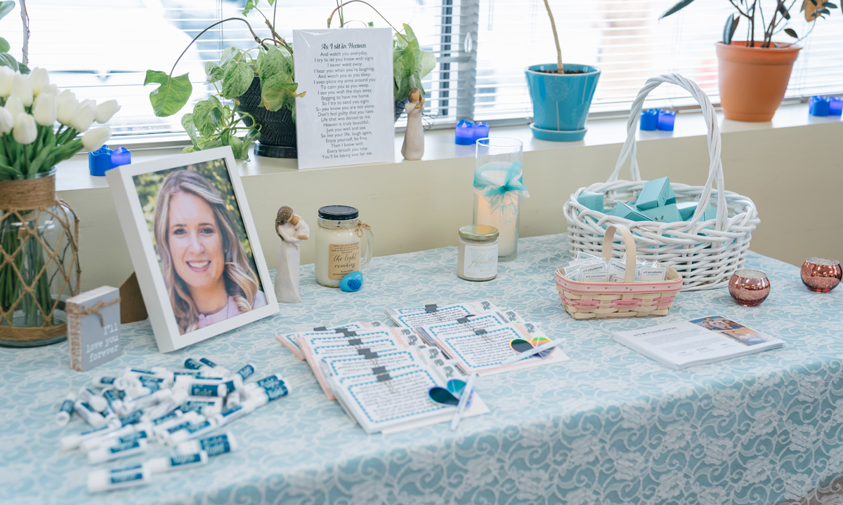 A table with a photo of Heather Shober, memorabilia, and information about amniotic fluid embolism. 