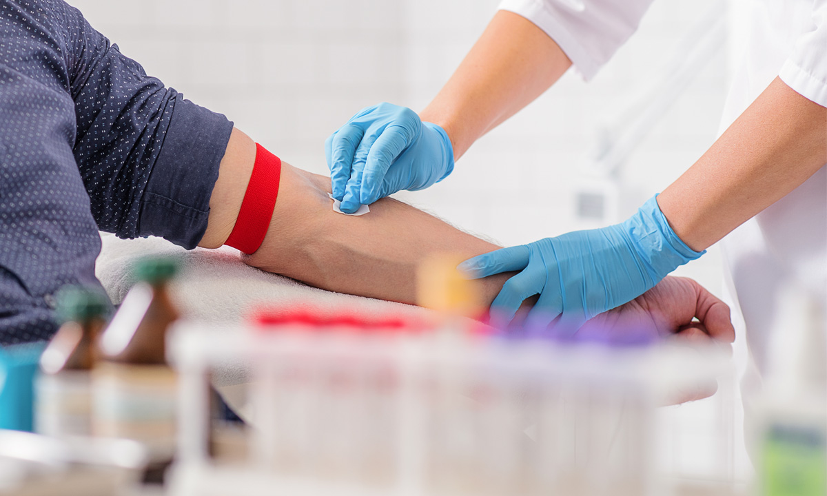 An individual is being prepped to donate blood