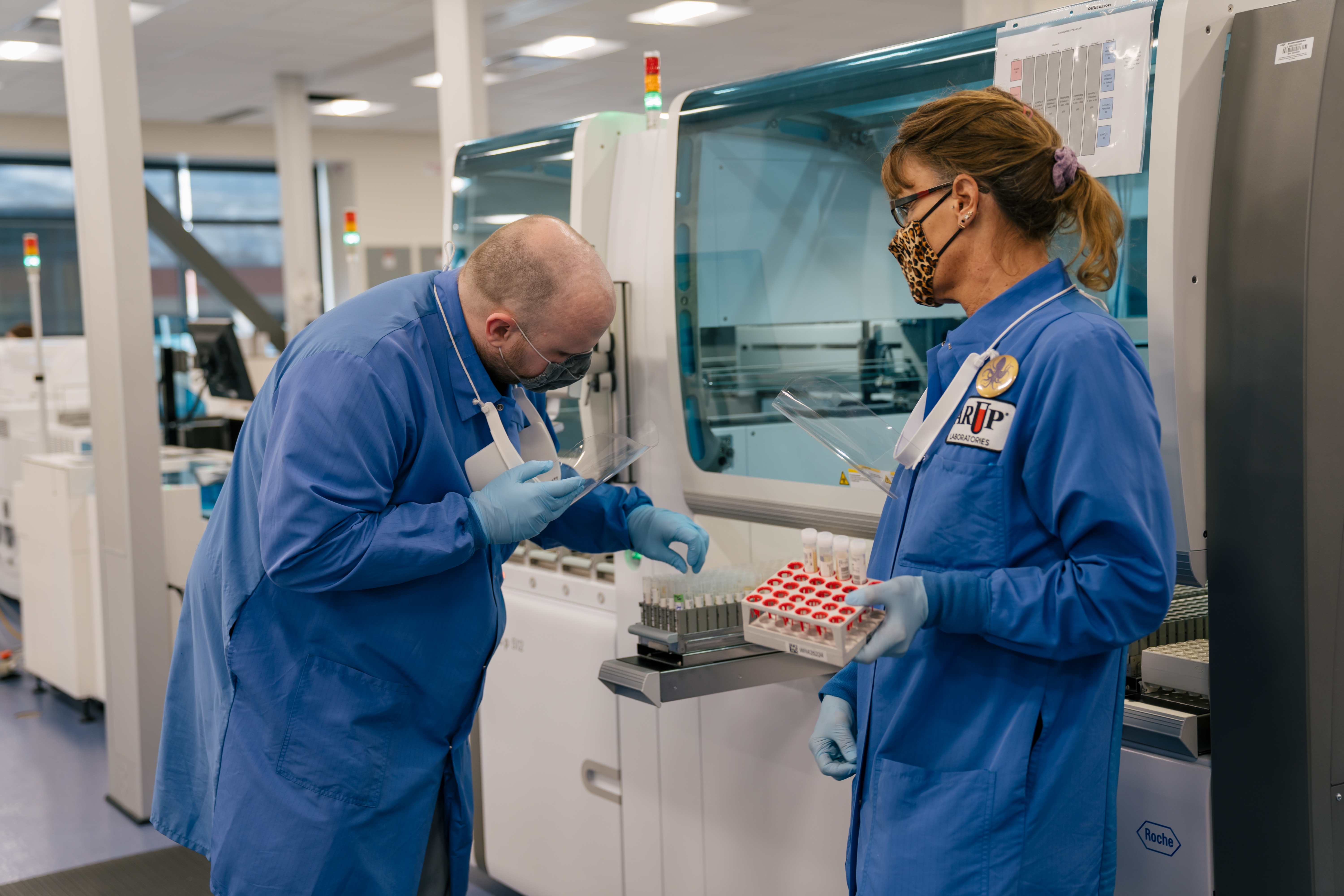 Specialists in the ARUP Automated Core Lab examine specimens