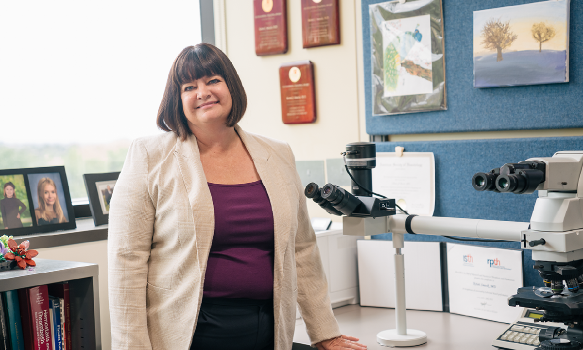 Kristi Smock, MD, stands in her office.
