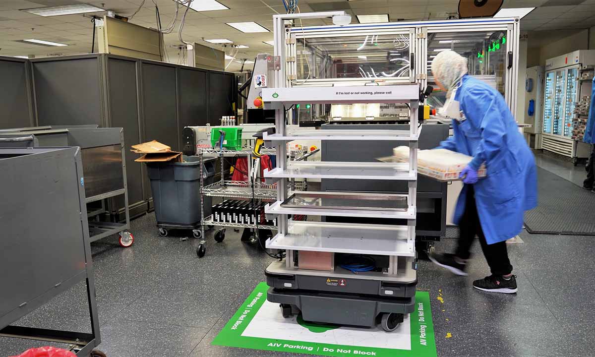 A lab tech unloads test samples from ARUP’s latest autonomous intelligent vehicle