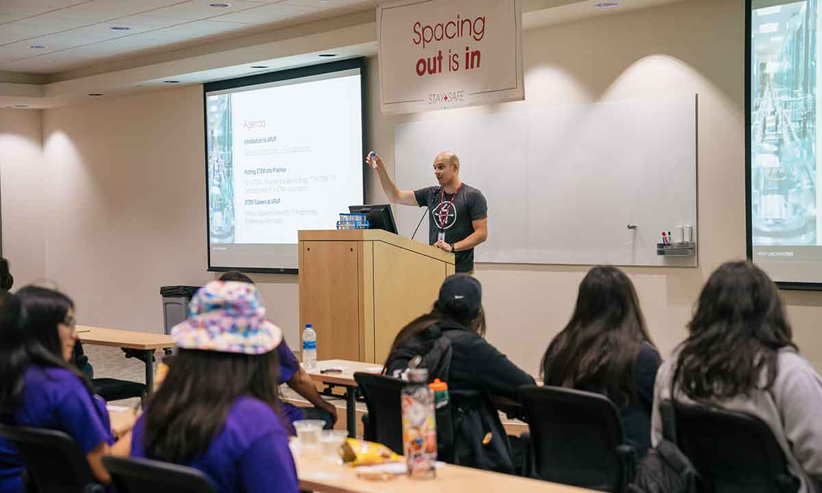 Skyler Harrison speaks to a group of Native Americans