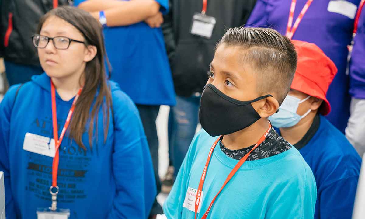 Jason Jensen and another student are in a lab during a STEM presentation