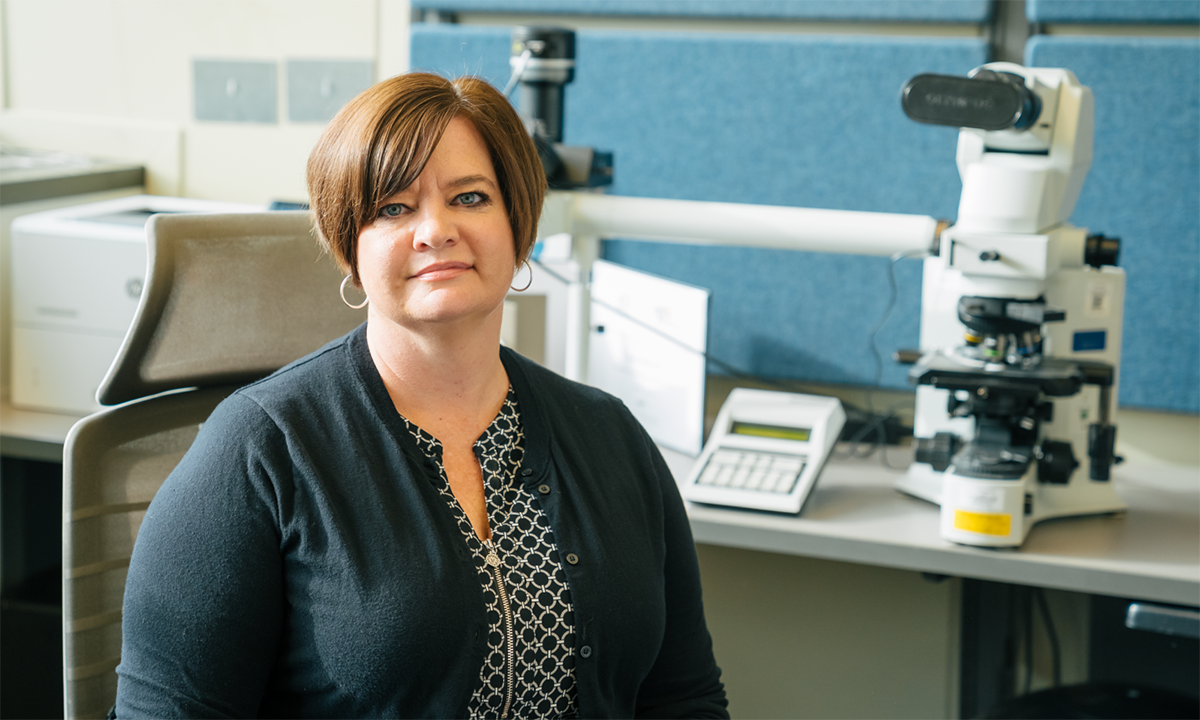 Kristi Smock sits in a laboratory.