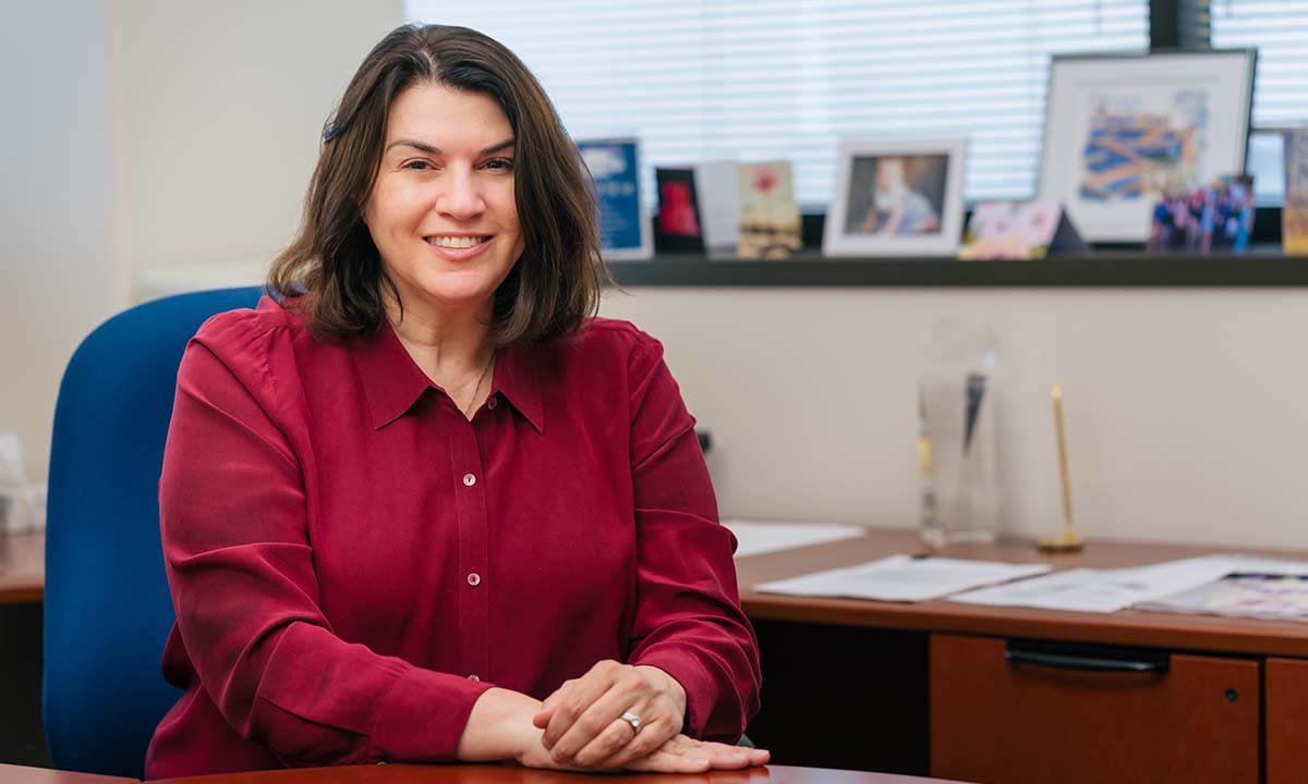 Tracy I. George sits at her desk