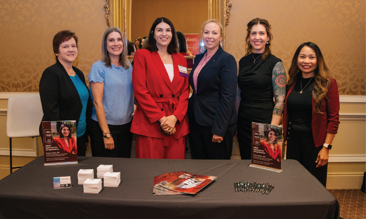 From left to right, Toni Pollock, Margaret Coppin, Tracy George, Sarah Teofilo, Erica Clyde, and Ligaya Kuiken, stand behind a table with brochures.