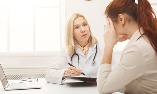 A clinician talks to a patient