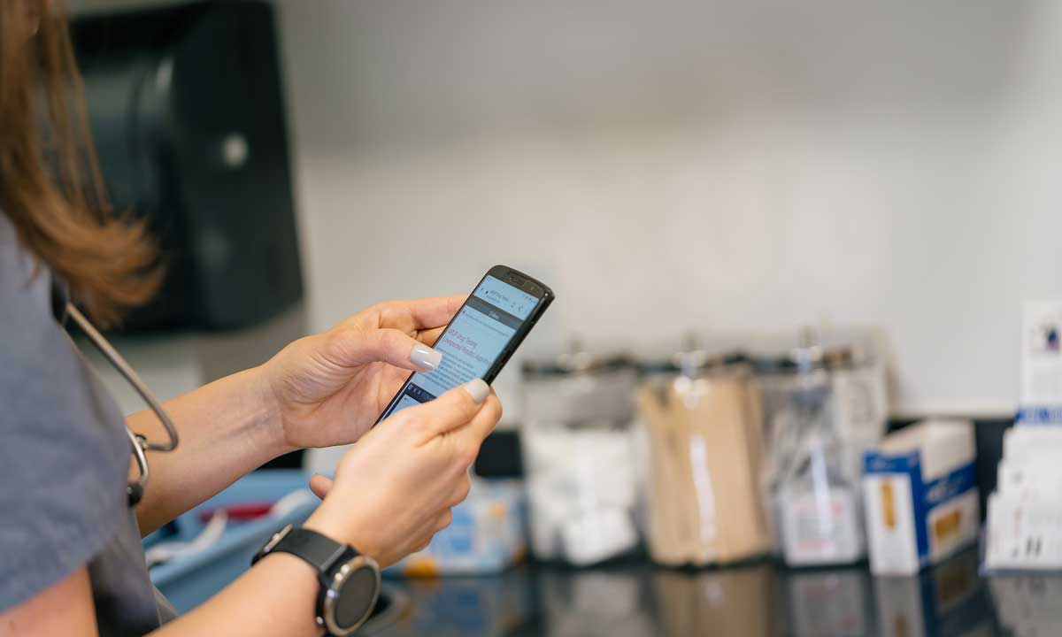 A clinician uses ARUP Consult on a mobile phone