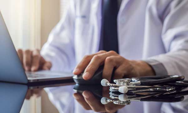 A doctor using a laptop