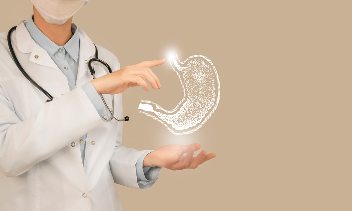 Photo illustration of a clinician holding a floating stomach.