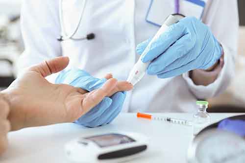 Lab technician taking blood sample from patient