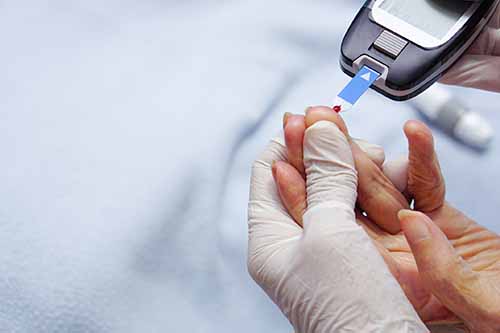 photo of a person taking a blood sugar test