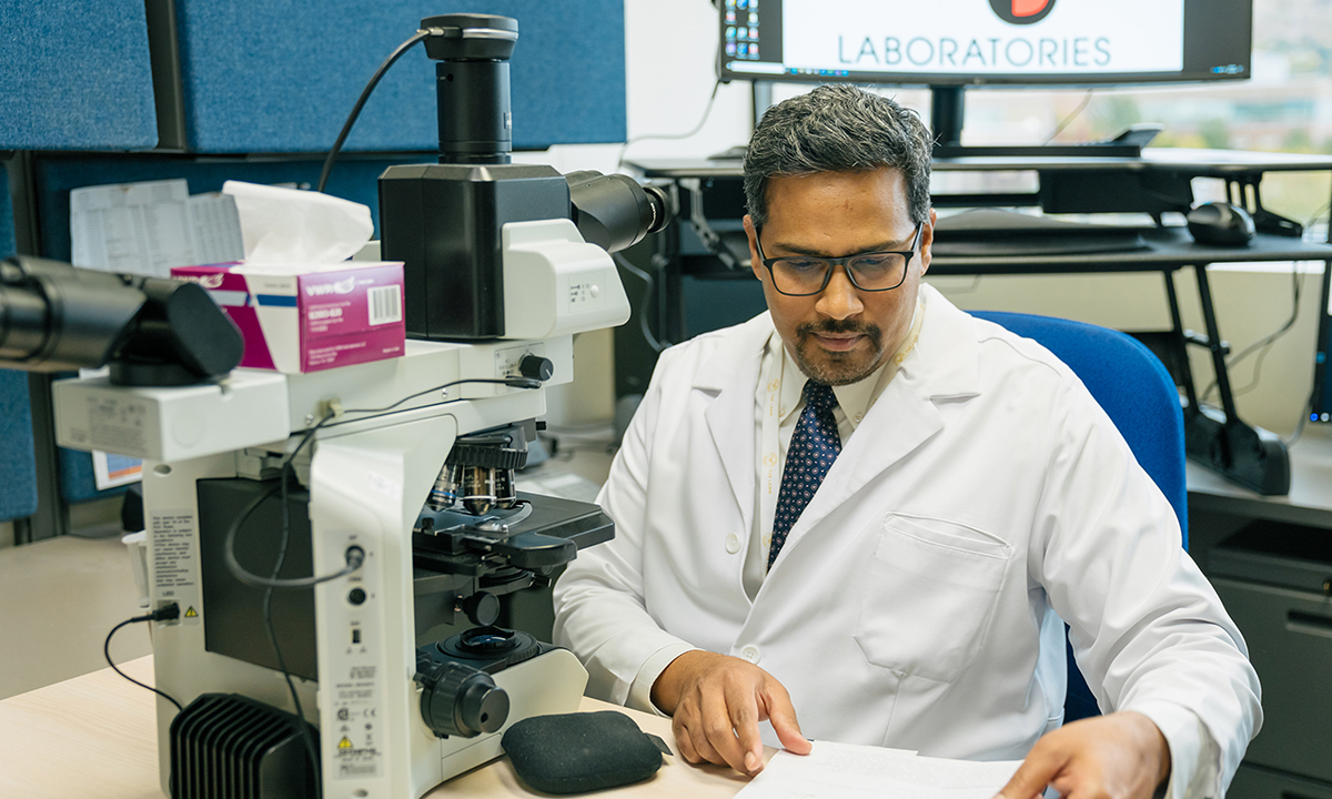 Madhu Menon in a lab