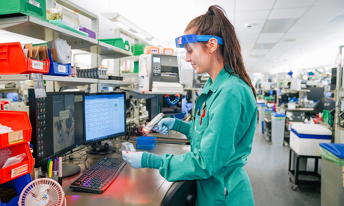 Female lab tech scanning specimen into system