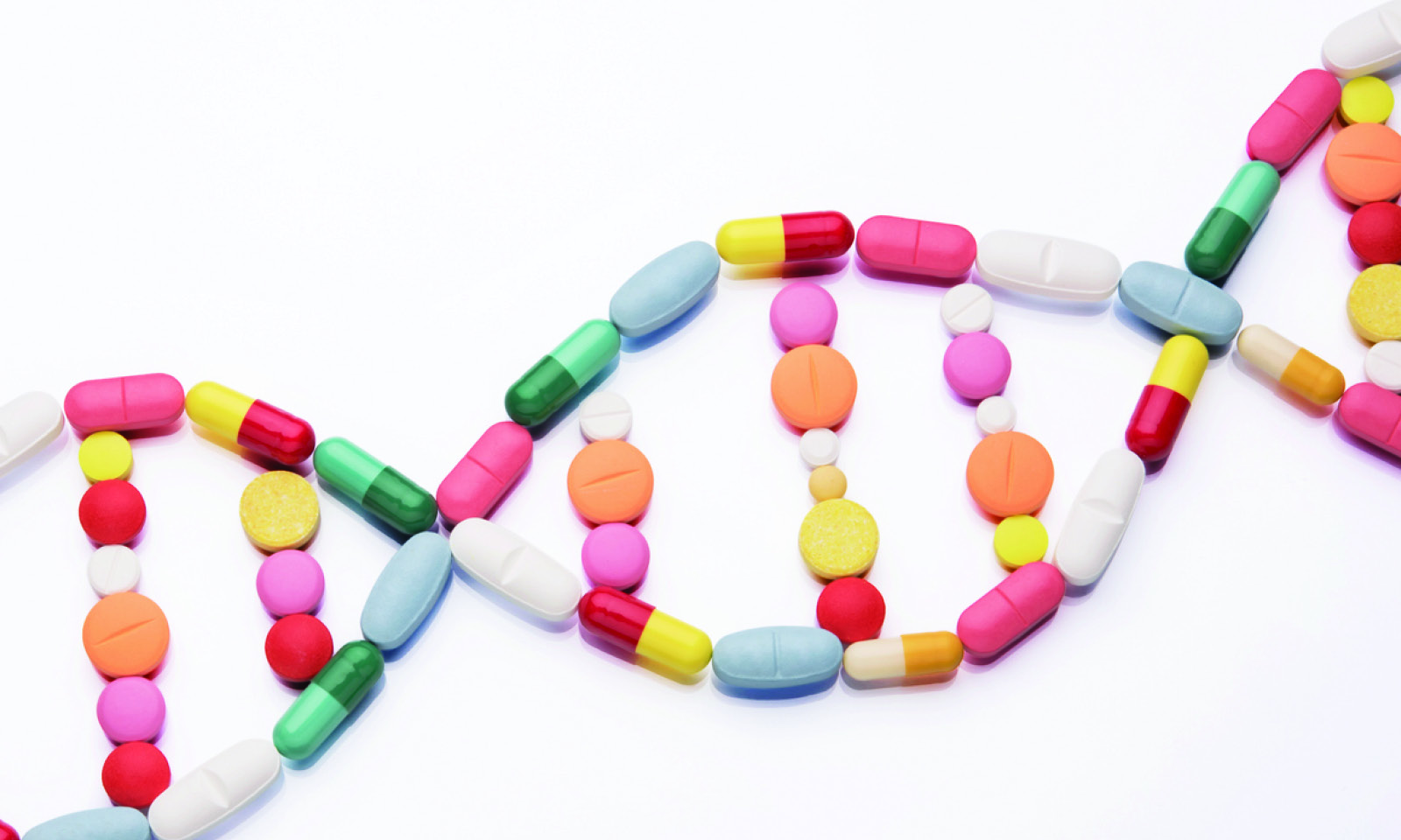 Pills laid out on a table in the shape of a double helix