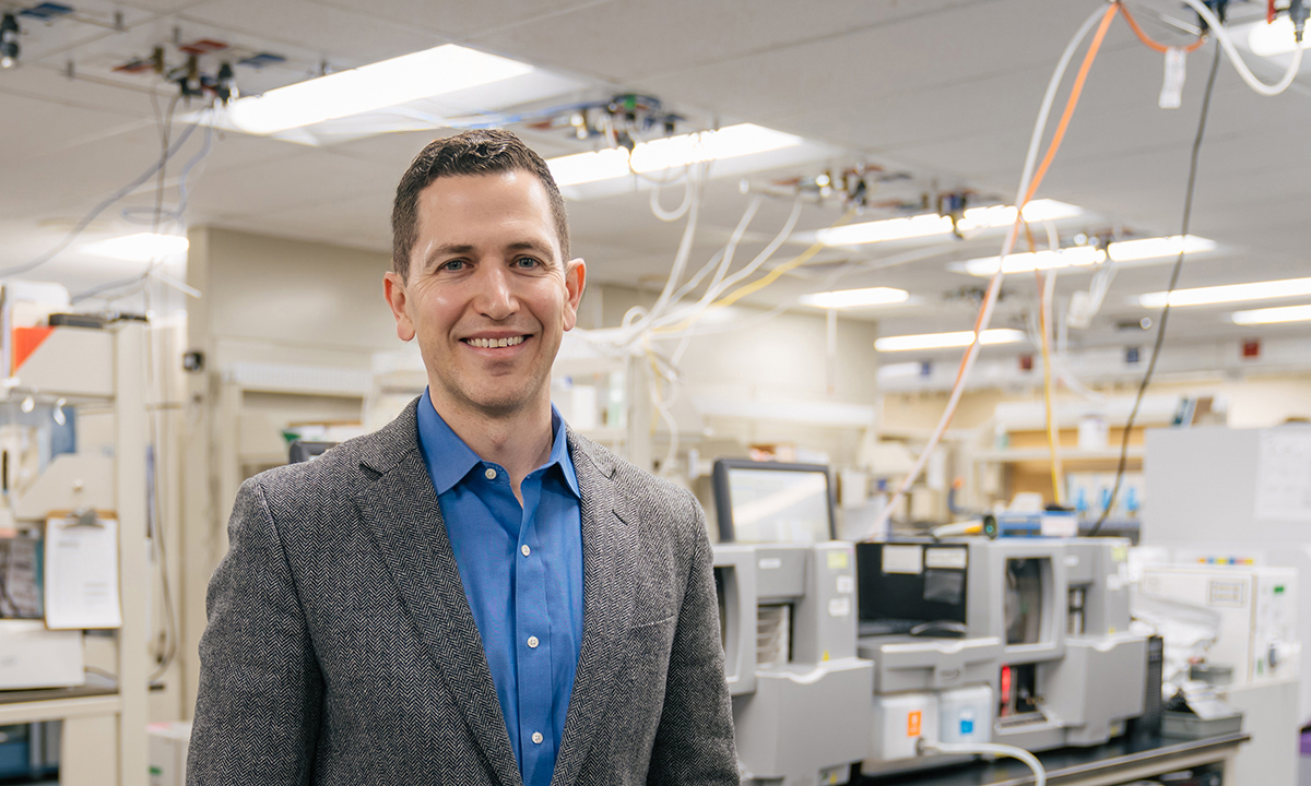 Ryan Metcalf, MD, stands in a lab.