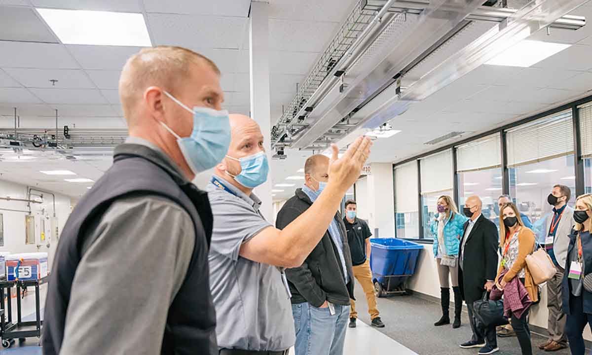 Zachary Wilkey explains features of ARUP’s laboratory automation system to members of the Association of University Research Parks (AURP) during a tour.