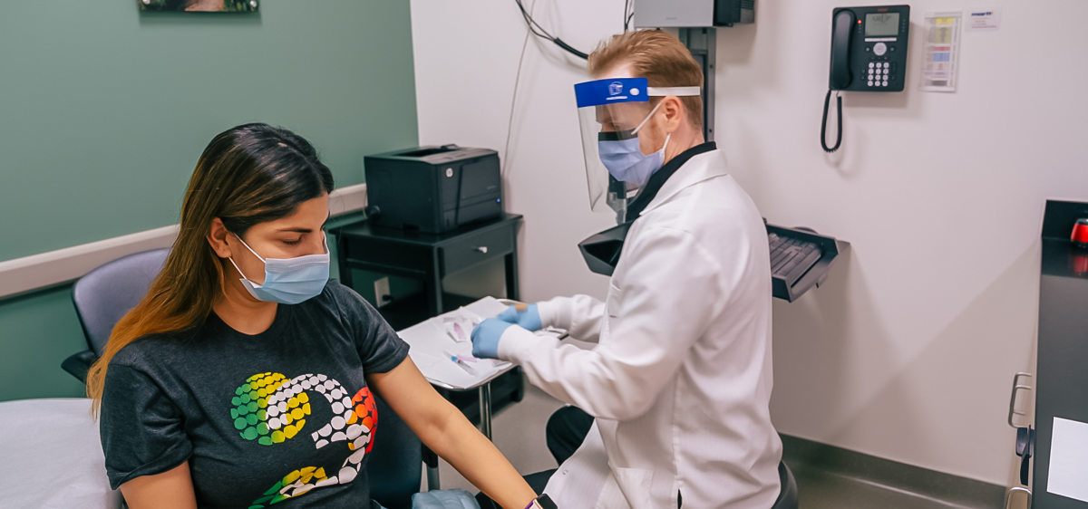 An ARUP Family Health Clinic employee administers a SARS-CoV-2 vaccine to an employee in the clinic