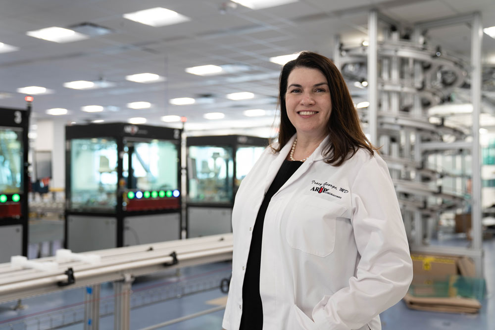 Tracy George stands smiling in the lab