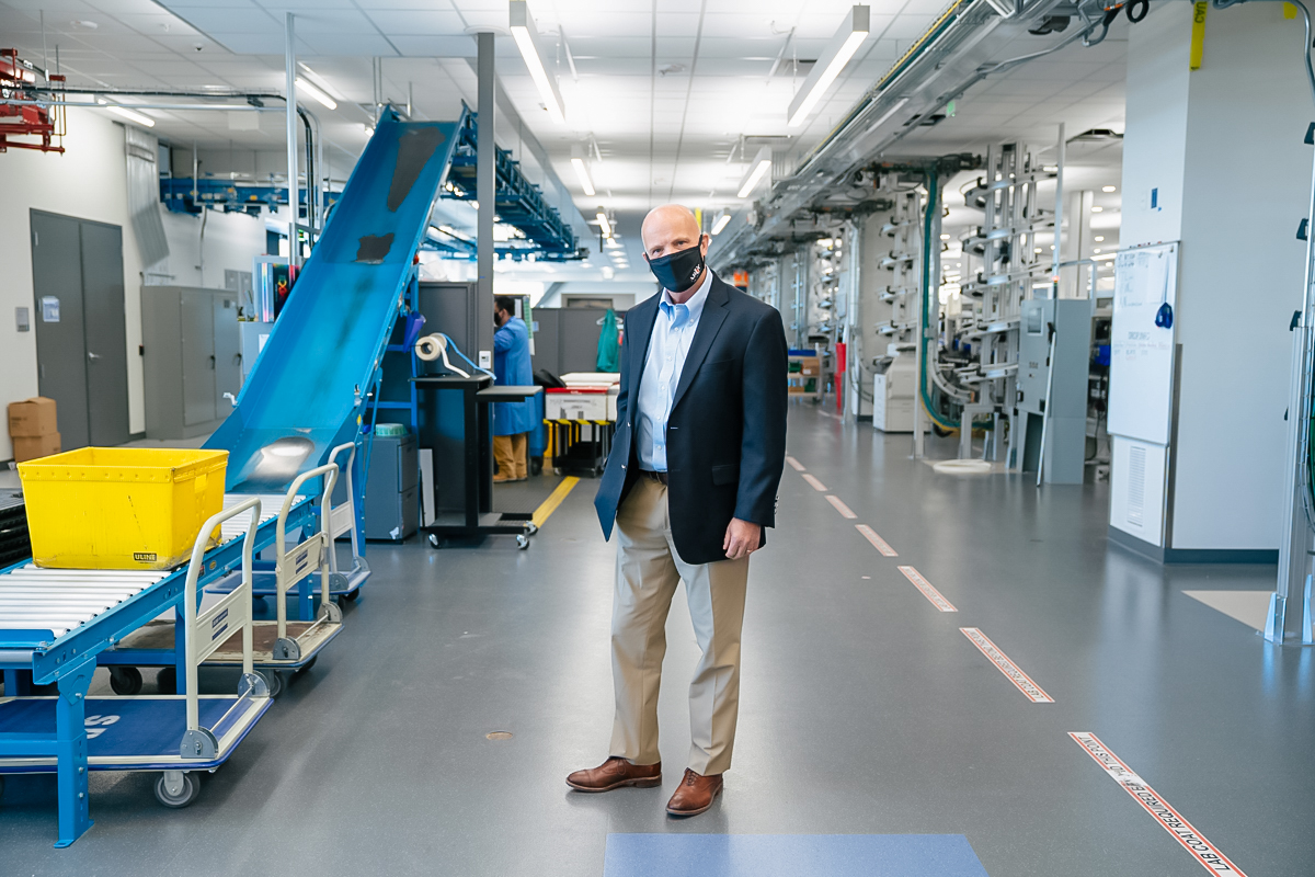 Andy Theurer stands in the lab wearing a face mask