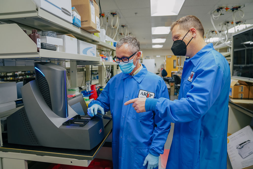 Devin Close and Marc Elgort examine lab equipment