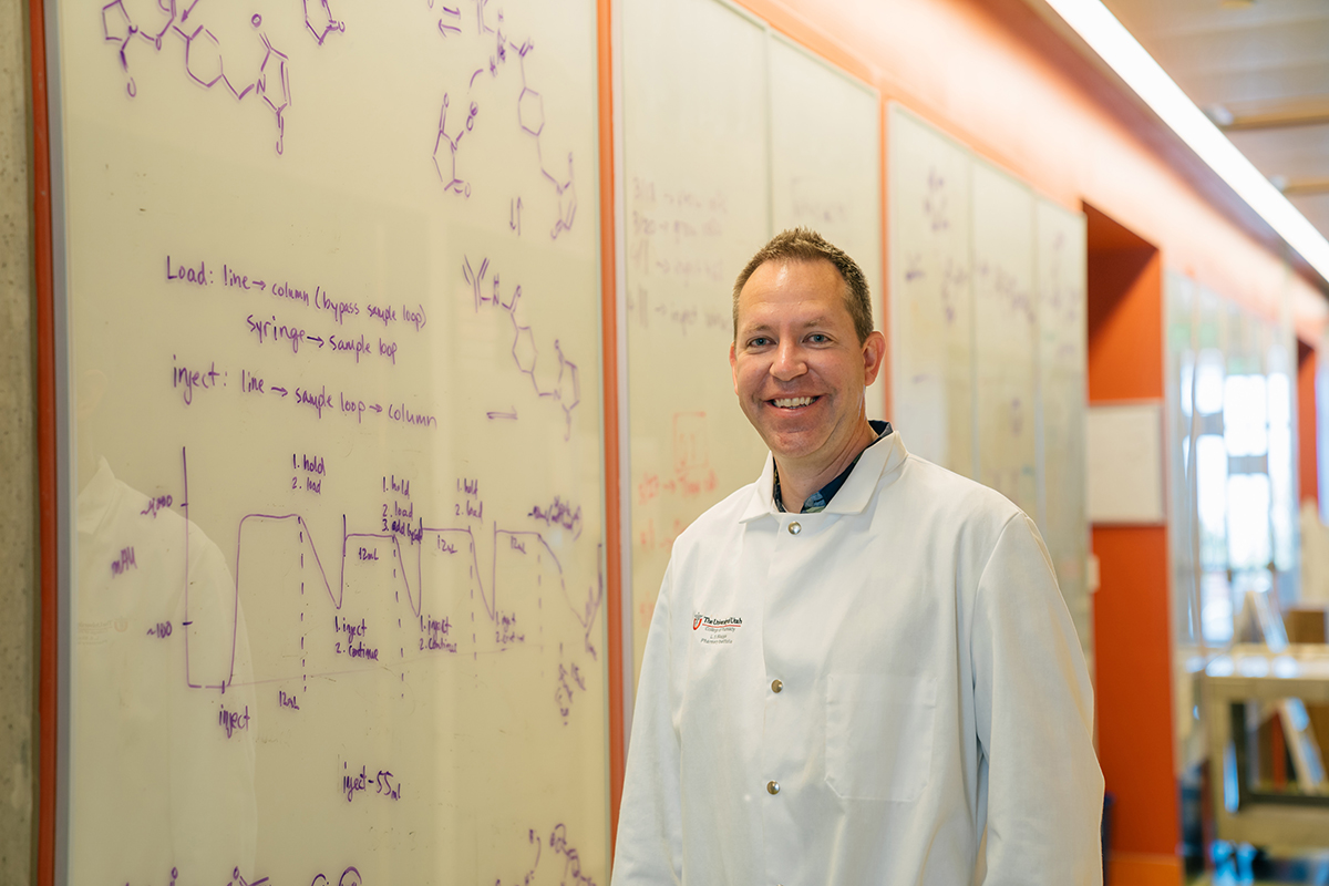 University of Utah associate professor Shawn Owen in front of a whiteboard