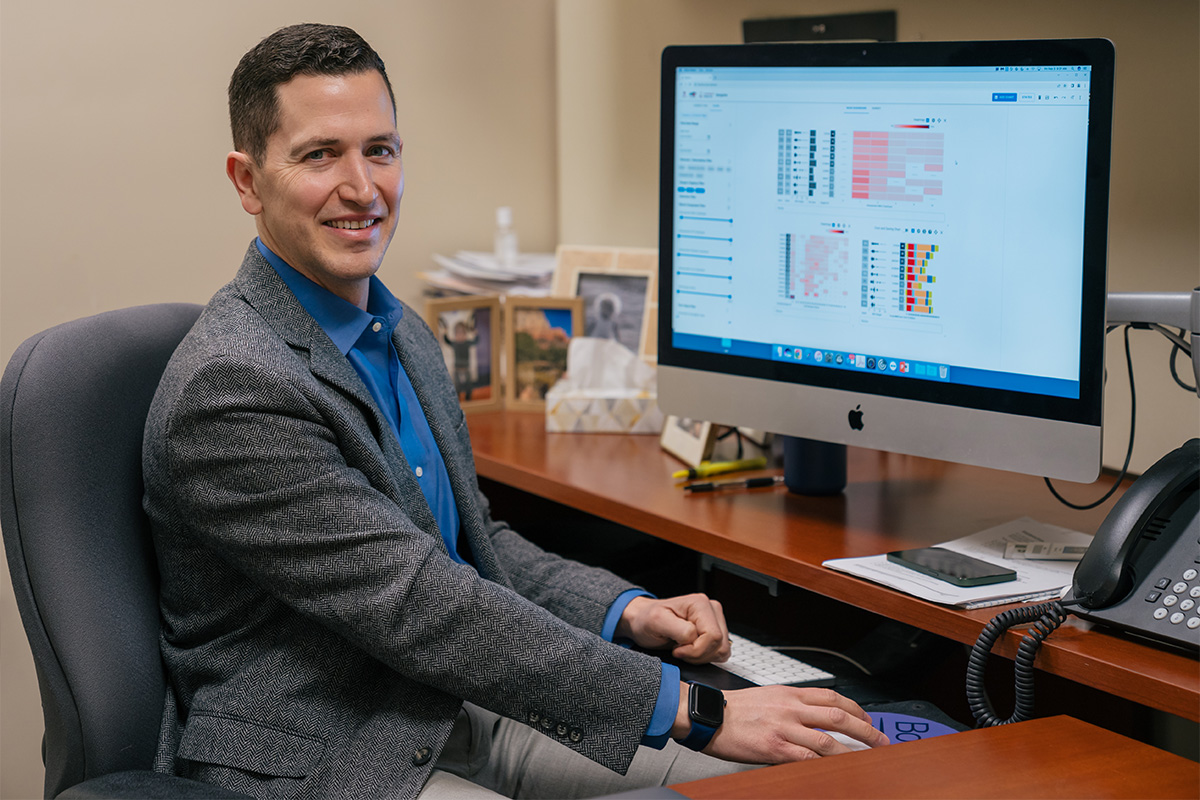 Ryan Metcalf demonstrating a data visualization tool on his computer