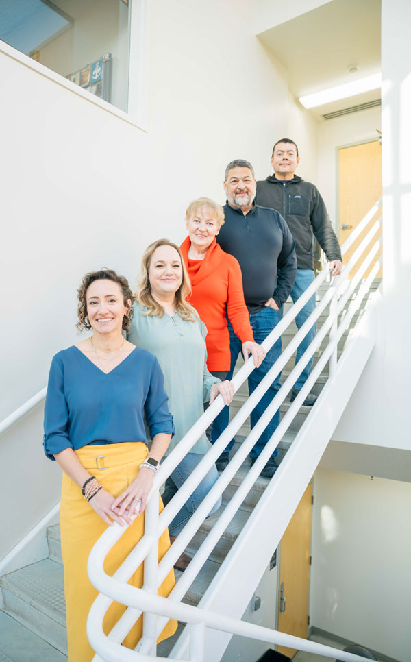 A group of technologists on a staircase