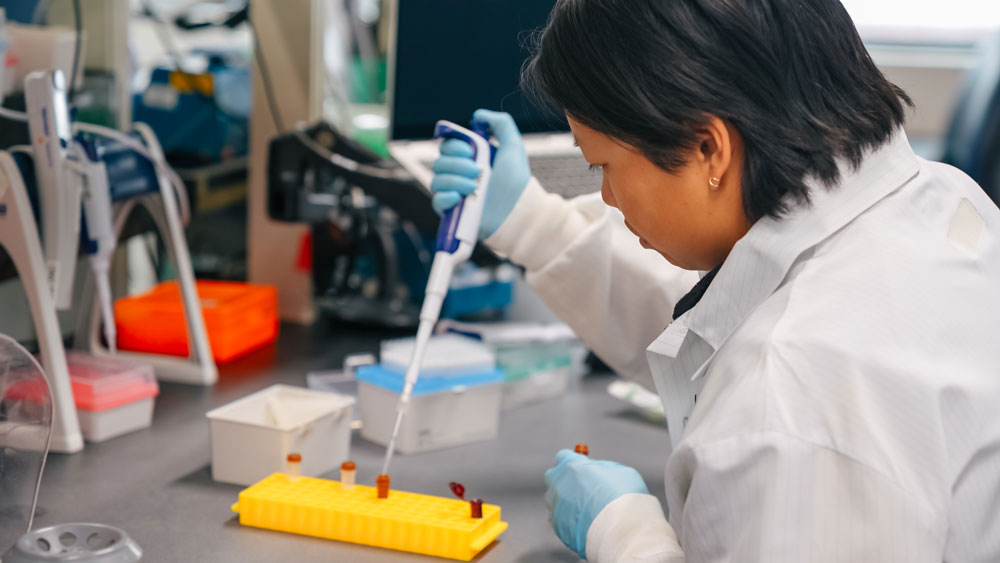 A lab worker preparing a mix