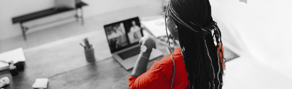 The back view of a woman using a laptop