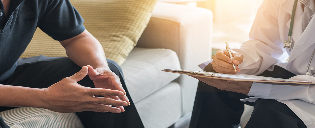 close up of the hands of a patient speaking to a clinician 