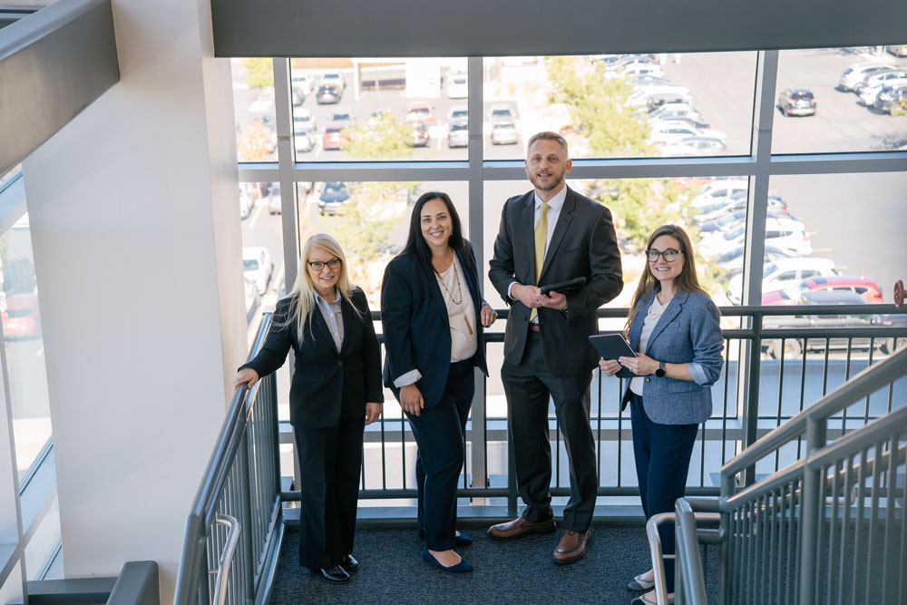 AHAS team members standing in front of a window